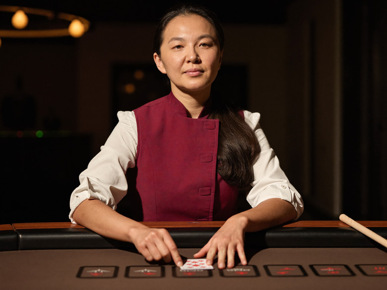 Evolution baccarat dealer at the table